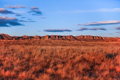 monument valley under white clouds during daytime saturated zoom background