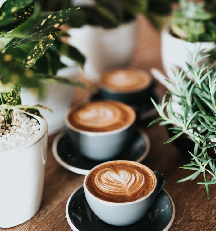 shallow focus photography of coffee late in mug on table