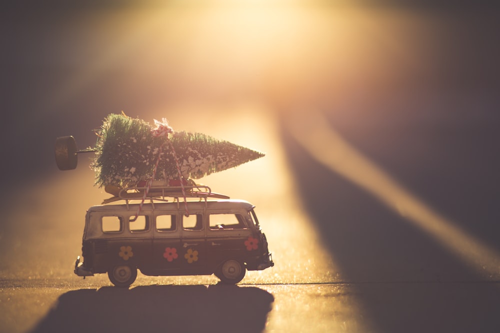 white and black bus with green pine tree scale model