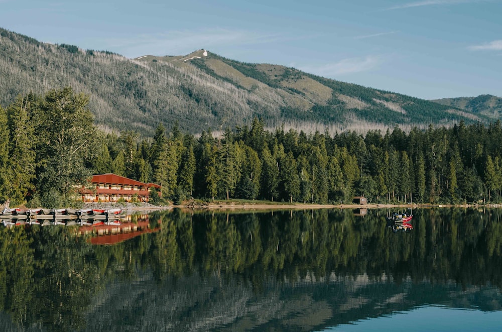 red and beige house in front of body of water