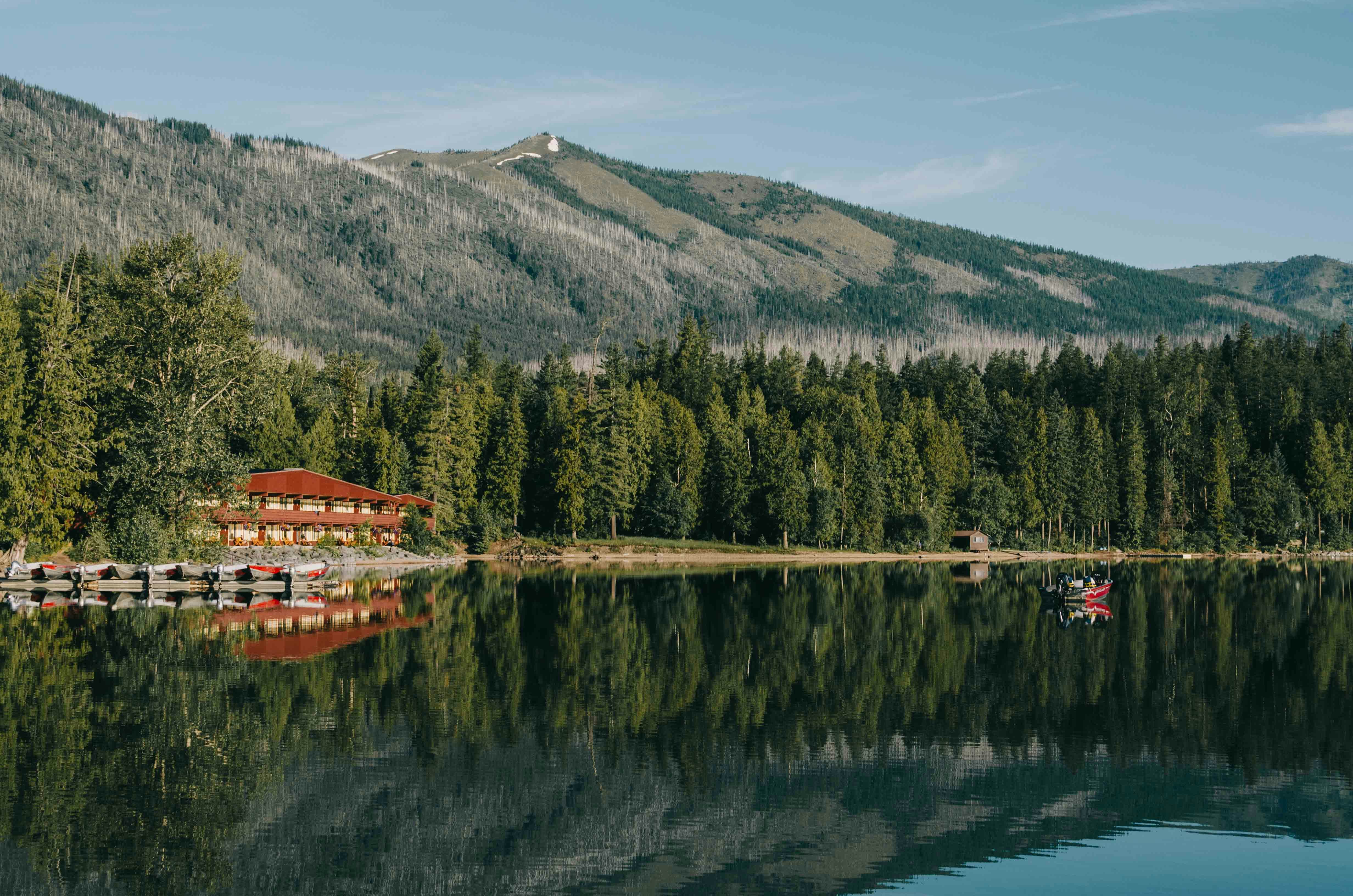 red and beige house in front of body of water