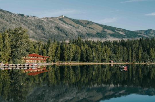 red and beige house in front of body of water in Lake McDonald United States