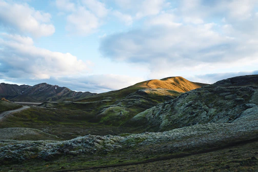 A serene landscape of rolling Scottish hills under soft morning light.