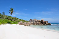 Pristine white sandy beach with crystal-clear water and vibrant coral reefs in Bali.