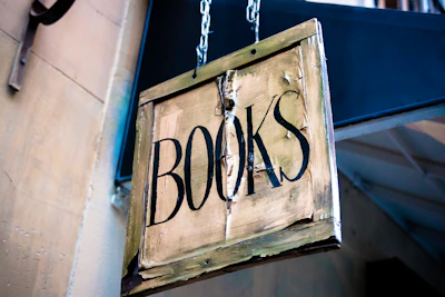 A rustic wooden sign hanging outdoors with the word 'Categories' burned into the wood.