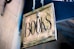 book signage hanging beside white wall