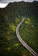 A panoramic view of a newly constructed highway cutting through lush Colombian landscapes.