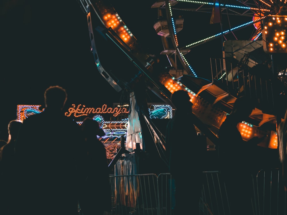 silhouette of person near Ferris wheel