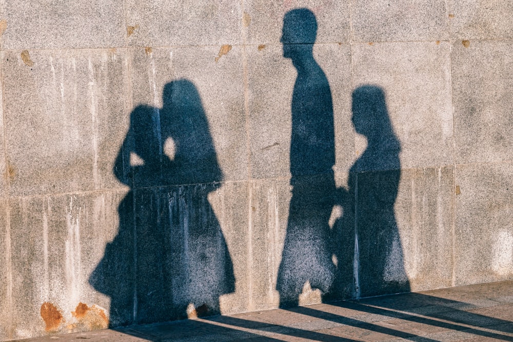 shadow of four people on wall