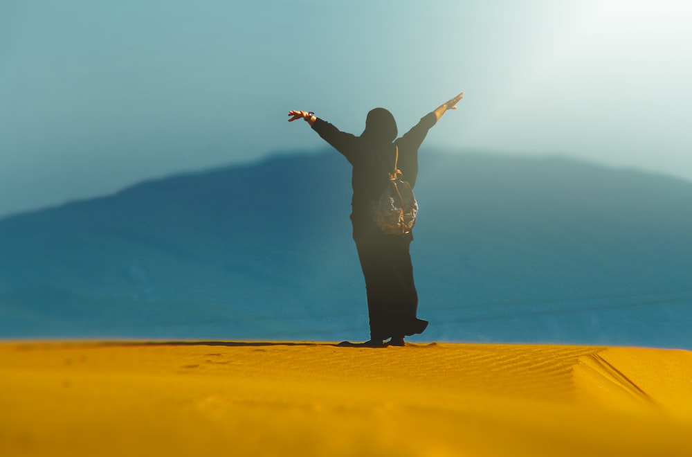 person standing on desert