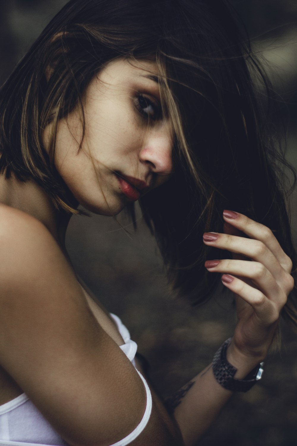 woman raising left arm wearing white shirt