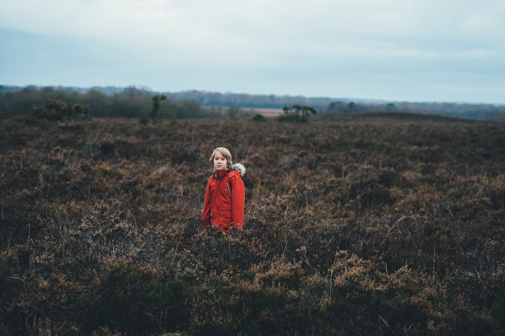 person standing in the middle of green plants