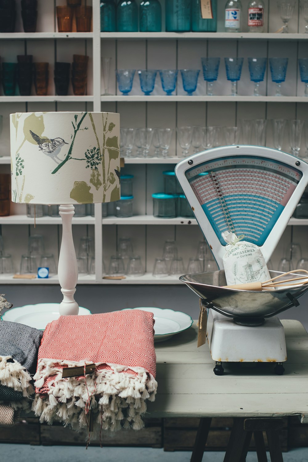 white desk lamp beside clothes on white table