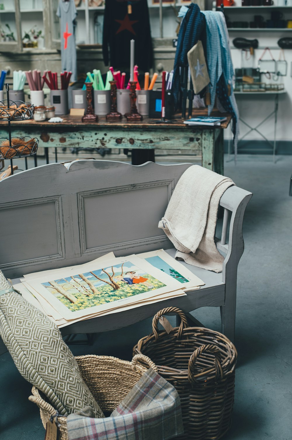 white wooden bench near two wicker baskets