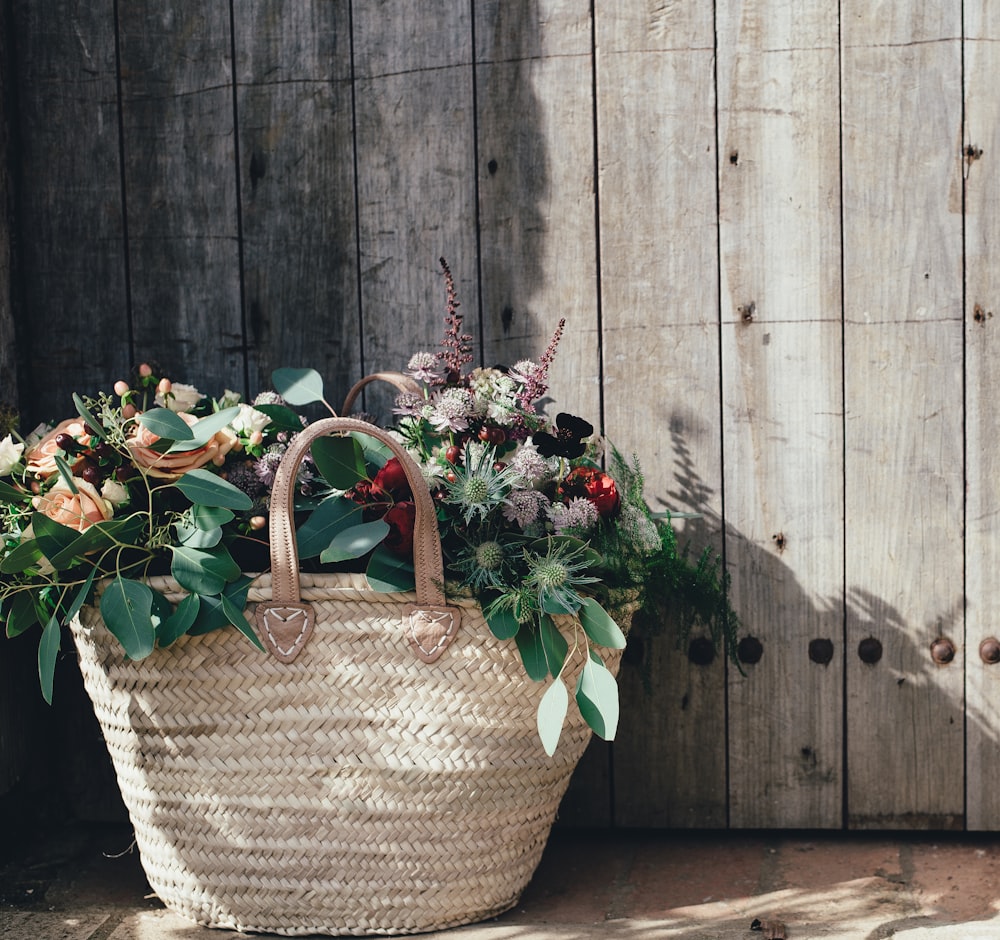 green and pink plant on woven basket