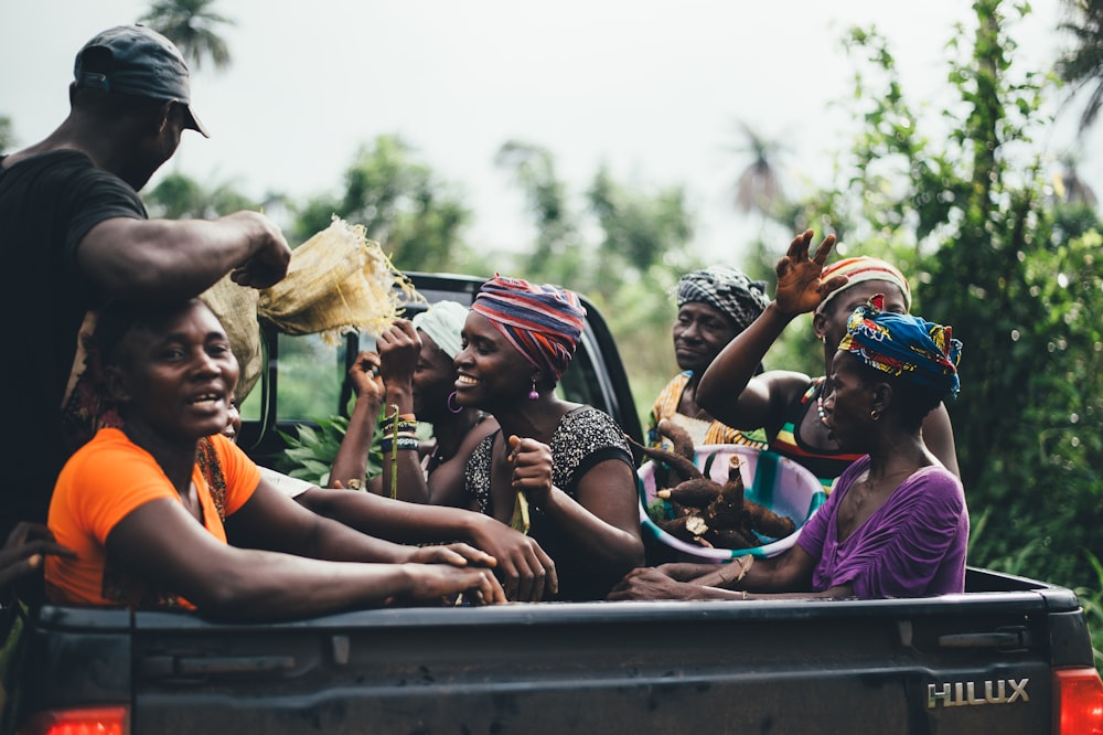 group of people on black Toyota Hilux truck bed