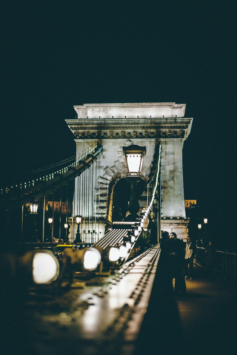 selective photography of bridge at night time