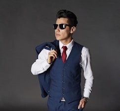 standing man with suit and sunglasses