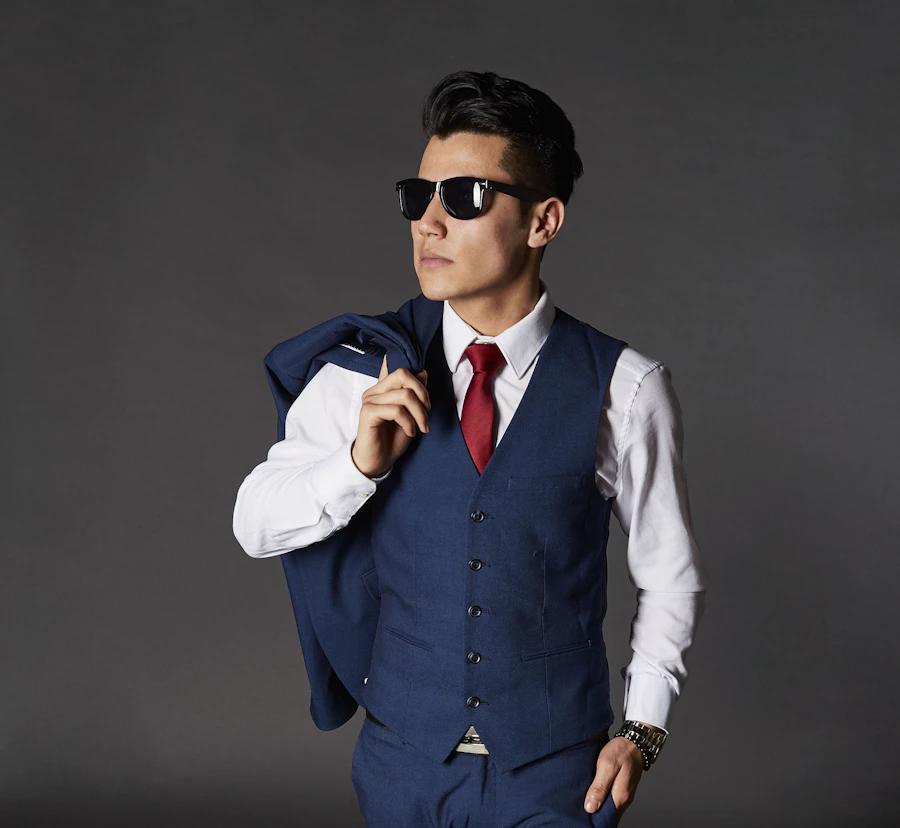 Man in a sharp suit and sunglasses showing the structured 80s men's dress clothes silhouette
