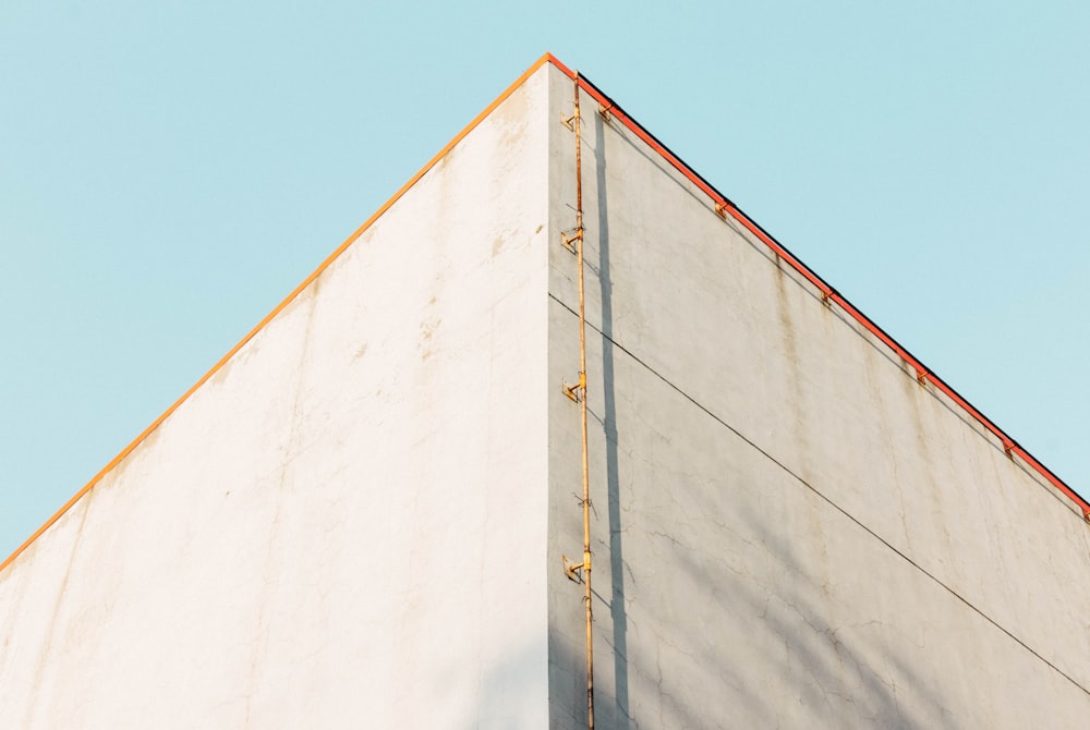 low angle photography of brown pipe near building