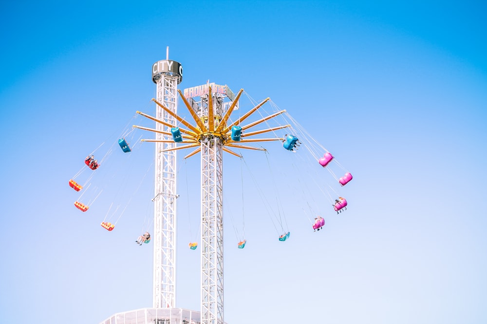 people riding swing amusement ride low-angle photography