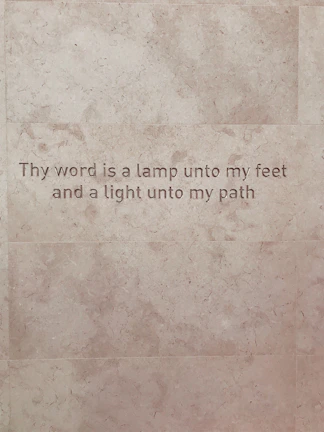 Artisan-crafted bracelets engraved with uplifting Bible verses resting on natural stone.