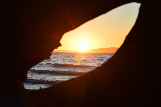 hole overseeing orange sunset in Saltwater State Park United States