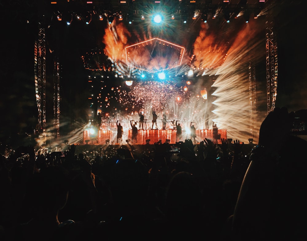 group of people on stage inside the building