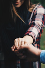 woman holding hands showing her ring