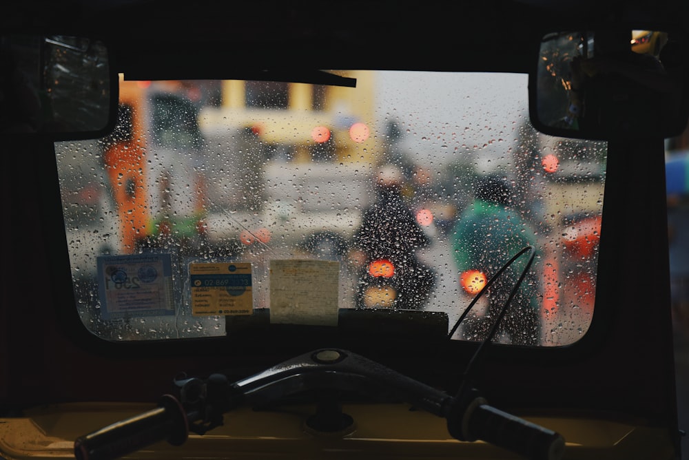 two persons riding on motorcycles during rain