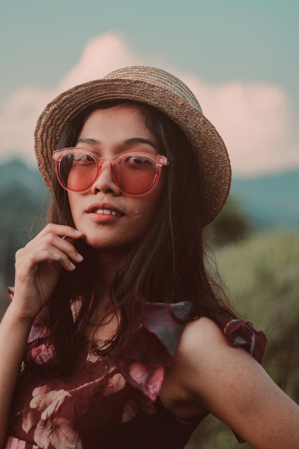 woman in brown wicker fedora hat posting