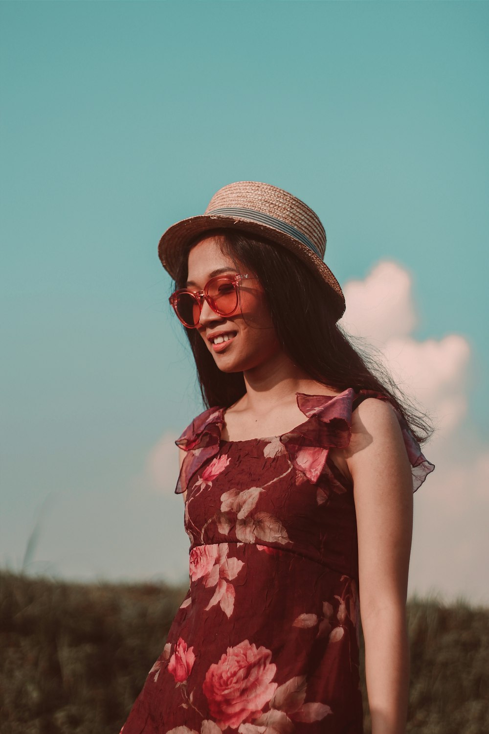 woman happily walking along a grass field