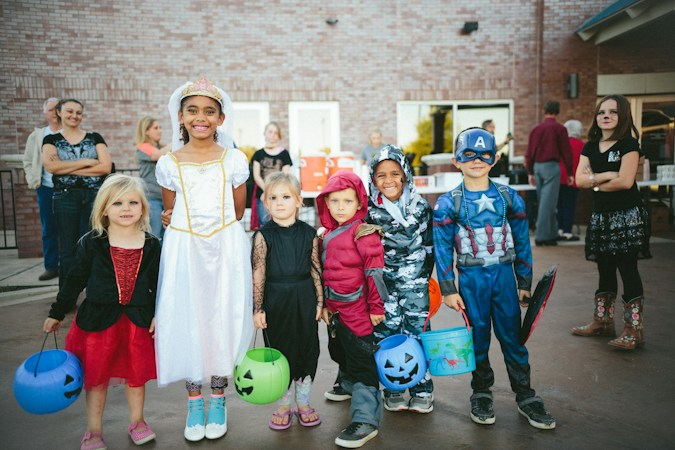 Children in Halloween costumes holding jack-o-lantern candy buckets, the kind of trick-or-treaters expected at Haunted Harvest in Las Vegas