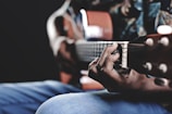 A close-up of hands playing a guitar.