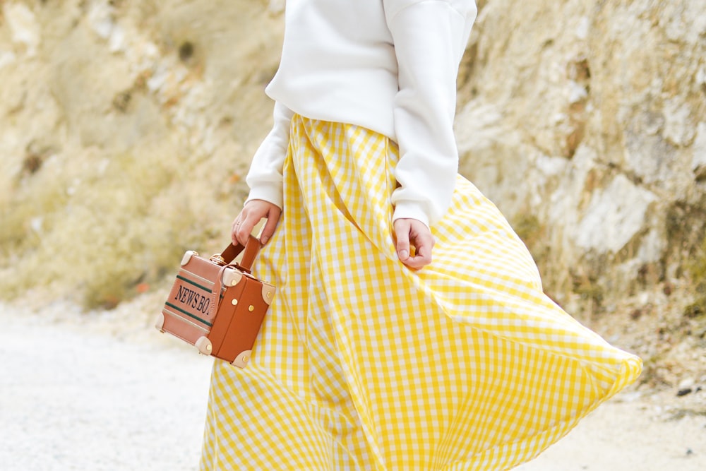 woman in yellow and white checked skirt