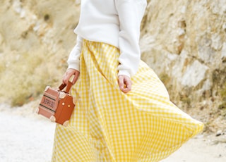 woman in yellow and white checked skirt
