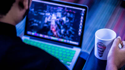 Close-up of hands typing on a keyboard with a matte forest green coffee mug nearby, evoking focused creativity.