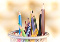 shallow focus photography of pencils on desk rack