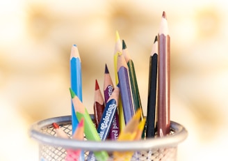 shallow focus photography of pencils on desk rack