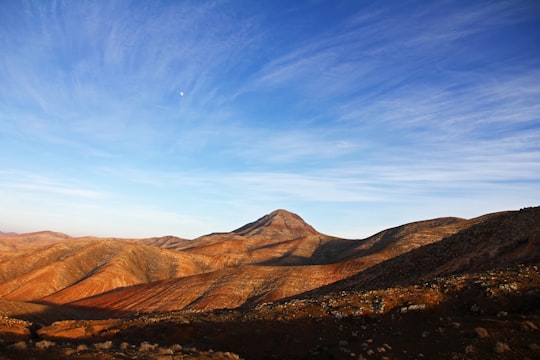 landscape photography of mountains under blue sky in Fuerteventura Spain
