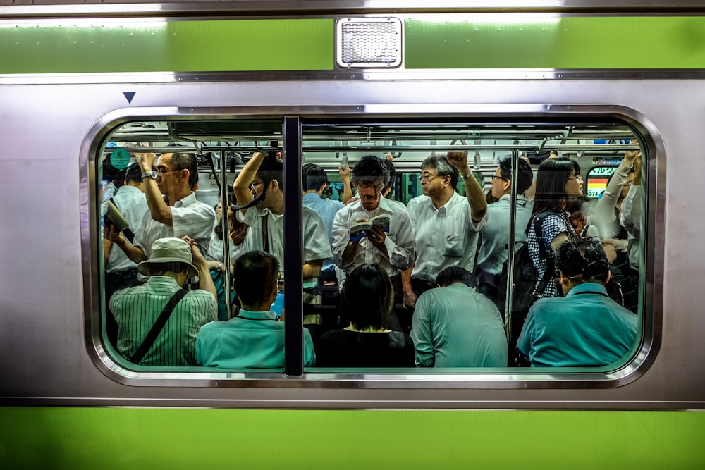 Gente sentada y de pie dentro del tren