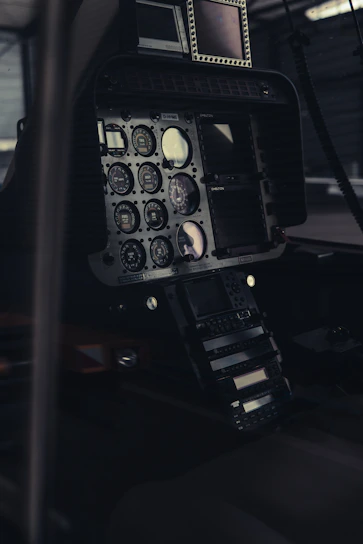 Close-up of sleek smart pilot glasses resting on a cockpit dashboard with a runway in the background.