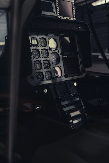 A close-up shot of a sleek airplane cockpit with vibrant flight control panels glowing softly.