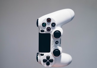 white Sony PS4 DualShock controller over person's palm