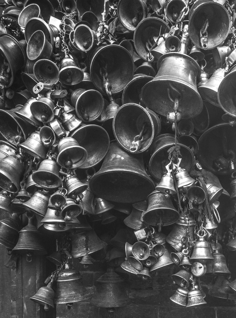 grayscale photo of bells