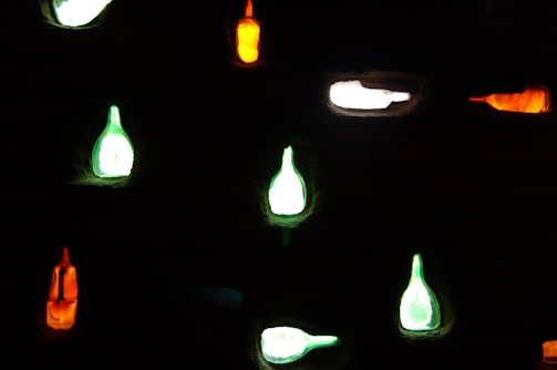 Light pouring through glass bottles of Rivage™ highlighting warm stone and blue-gray accents.