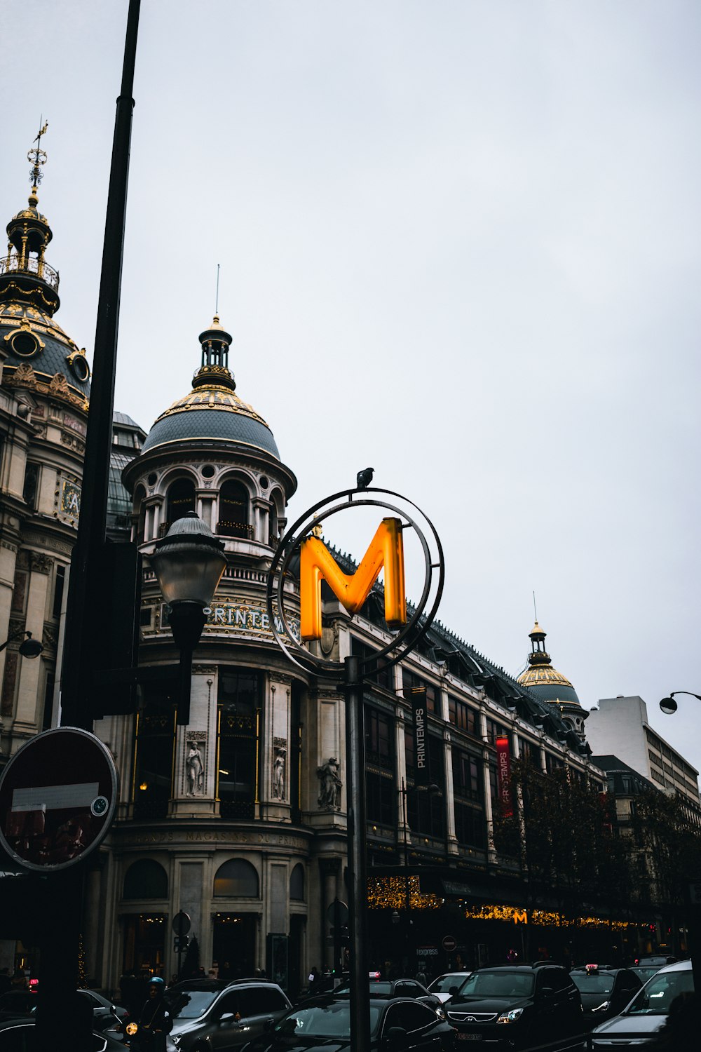 low angle photography of yellow M signage on road