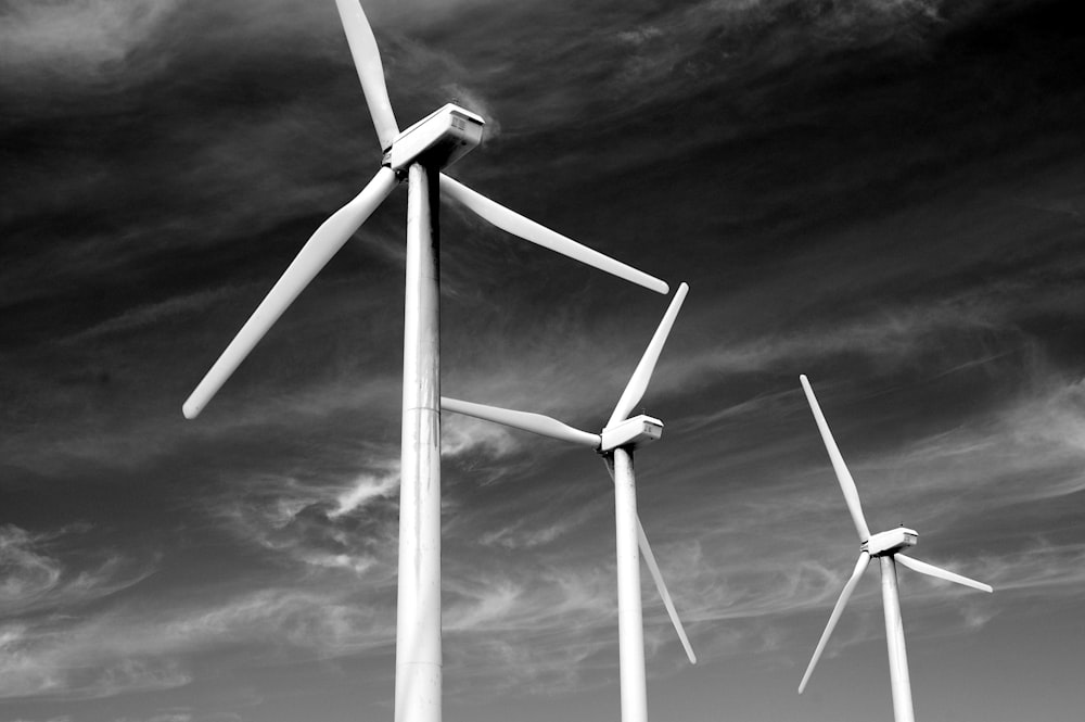 three windmills under clouds