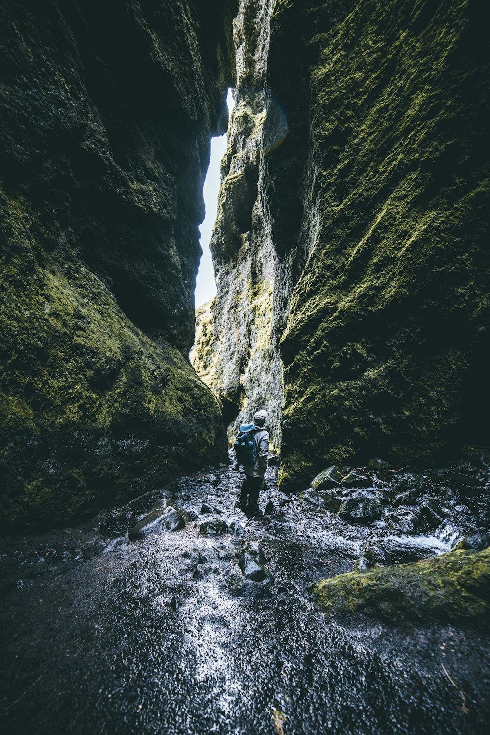 man standing in between of rock formations