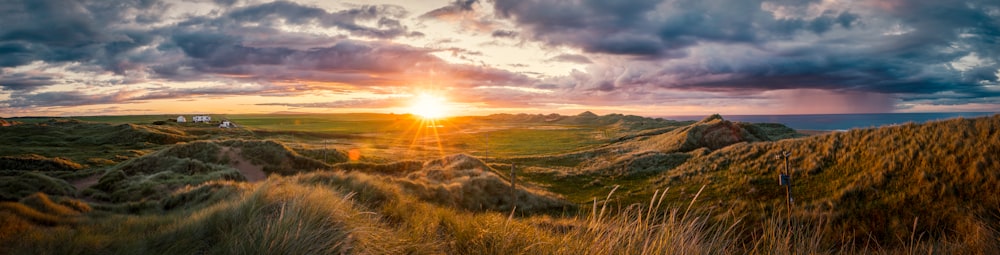 brown grass covered mountain taken during sunset